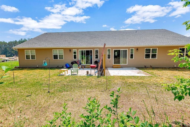 back of property with a patio area and a yard