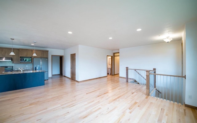 interior space with light hardwood / wood-style floors and sink