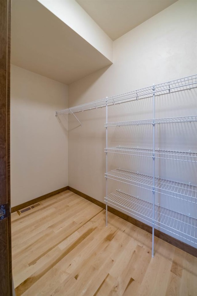 walk in closet featuring hardwood / wood-style floors