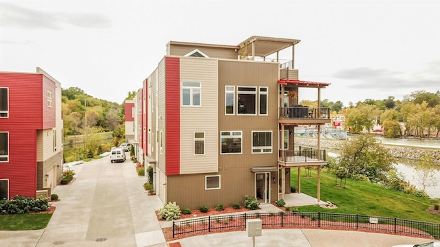 exterior space featuring a balcony and a lawn