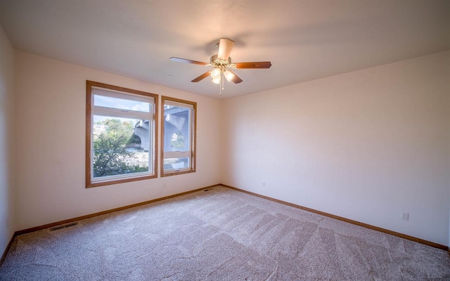 carpeted empty room with ceiling fan