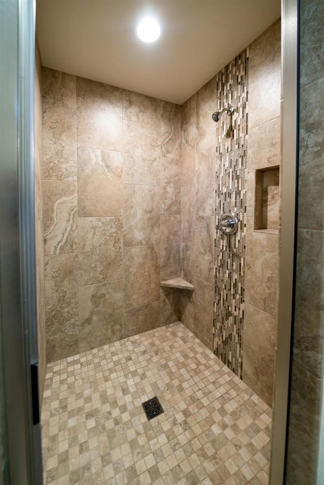 bathroom with tiled shower