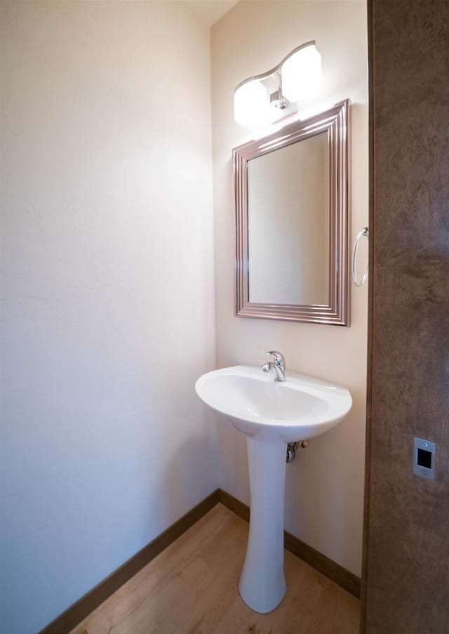 bathroom with hardwood / wood-style flooring and sink