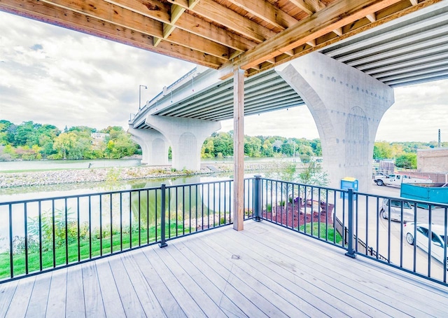 wooden terrace featuring a water view