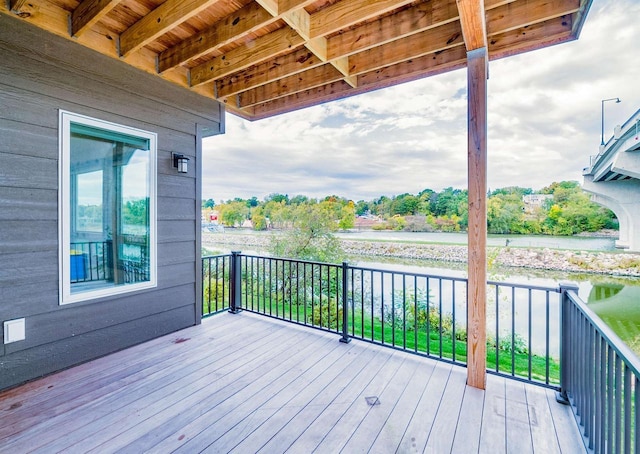 wooden terrace featuring a water view