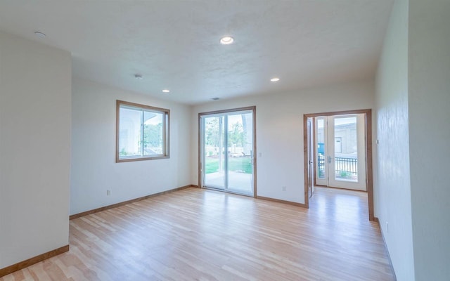 unfurnished room with light hardwood / wood-style floors