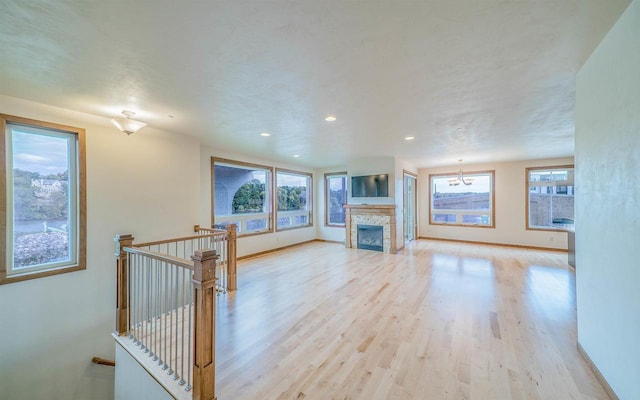 unfurnished living room with a fireplace and light hardwood / wood-style flooring