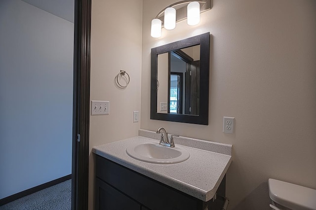 bathroom featuring vanity and toilet