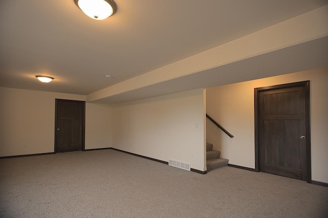 basement featuring light colored carpet