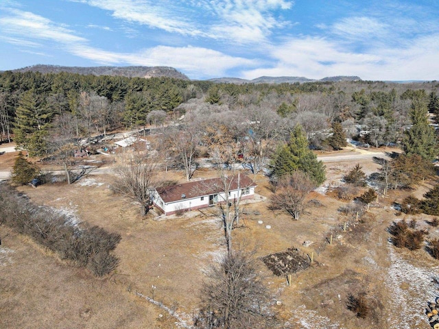 birds eye view of property with a mountain view and a forest view