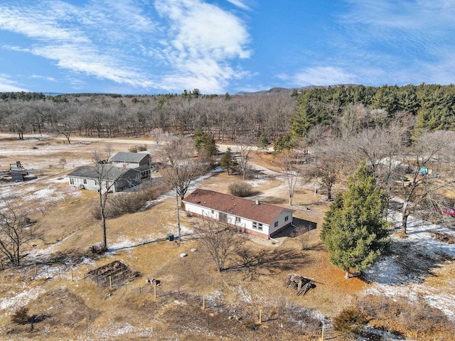 drone / aerial view with a wooded view