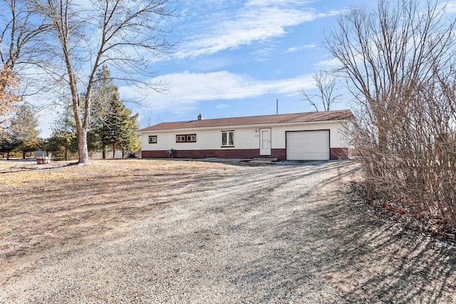 single story home featuring a garage and driveway