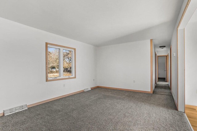 carpeted empty room with visible vents and baseboards