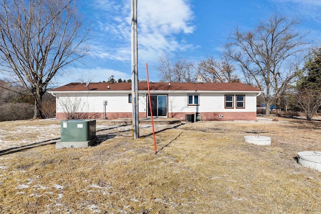 back of house featuring entry steps, cooling unit, and brick siding