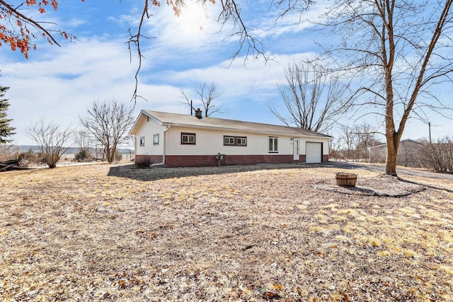 view of front of property featuring a garage and a chimney