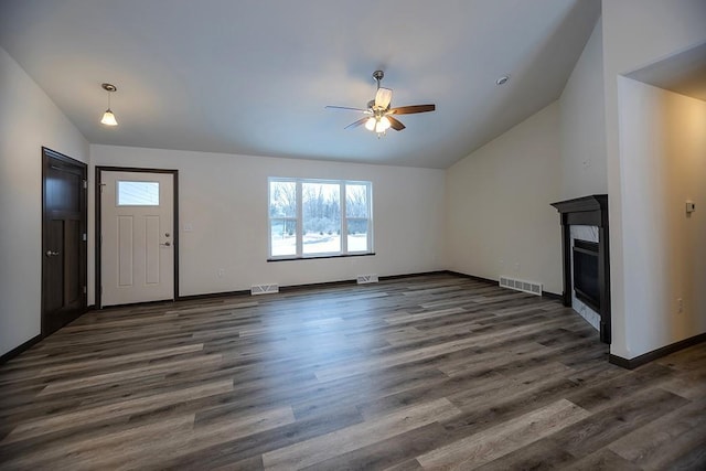 unfurnished living room featuring dark wood-type flooring, ceiling fan, and lofted ceiling