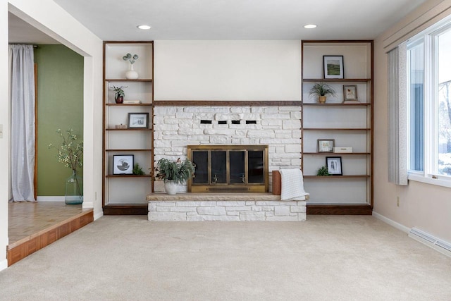 unfurnished living room featuring a stone fireplace and light colored carpet