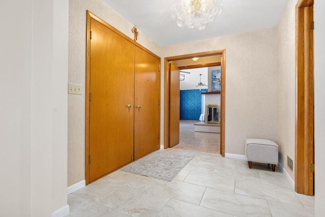 hallway with a chandelier