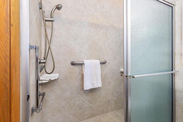 bathroom featuring a shower with door