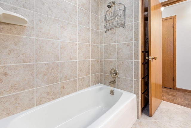 bathroom featuring tile patterned floors and tiled shower / bath