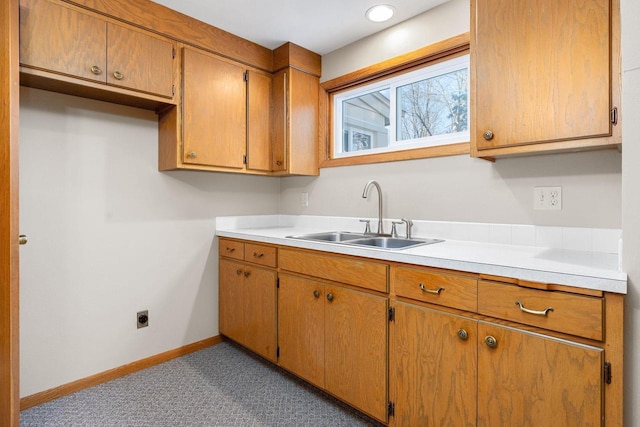 kitchen with light carpet and sink