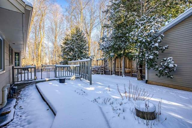 snowy yard featuring a deck