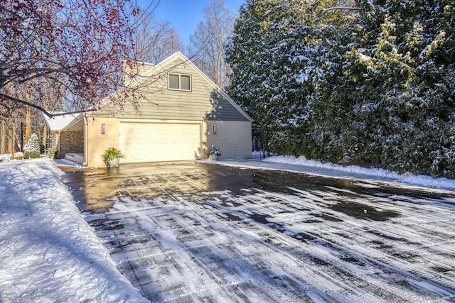 snow covered property featuring a garage