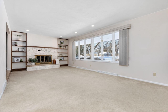 unfurnished living room with a fireplace and light colored carpet