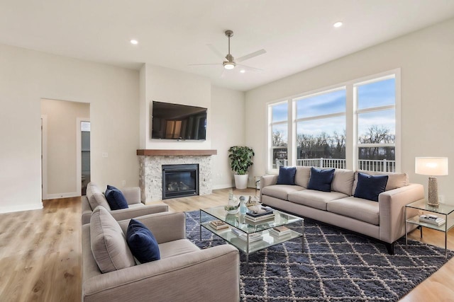 living room featuring hardwood / wood-style flooring and ceiling fan