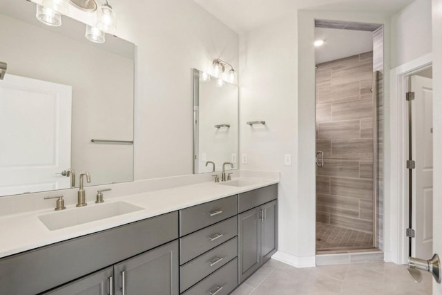 bathroom featuring tile patterned floors, vanity, and a shower with shower door