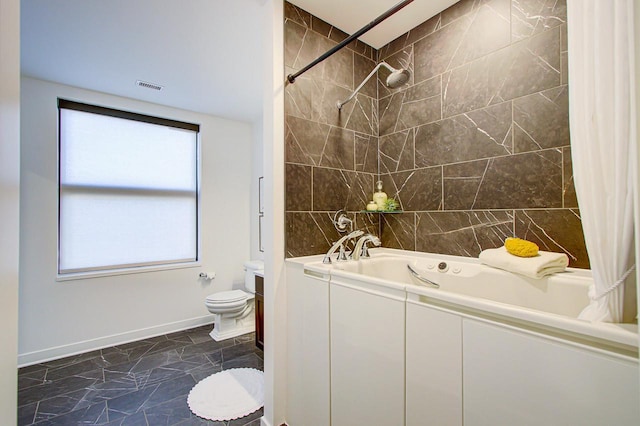 full bathroom with vanity, shower / bath combo with shower curtain, and toilet