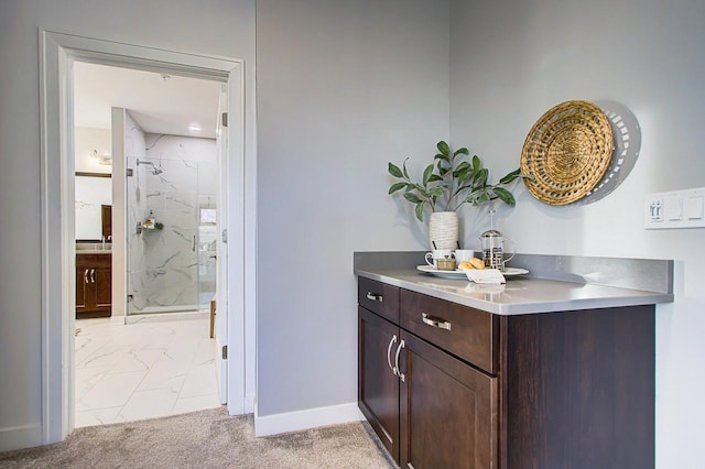 bathroom with a shower with door and vanity