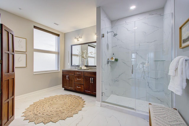 bathroom with vanity and a shower with shower door