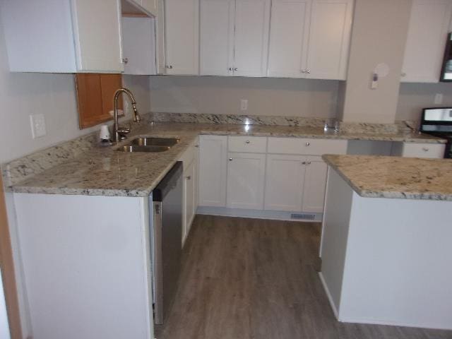 kitchen with white cabinets, dishwasher, sink, and dark wood-type flooring