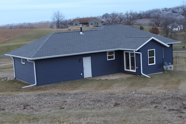 back of property featuring a rural view