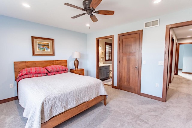 carpeted bedroom featuring ceiling fan and ensuite bath