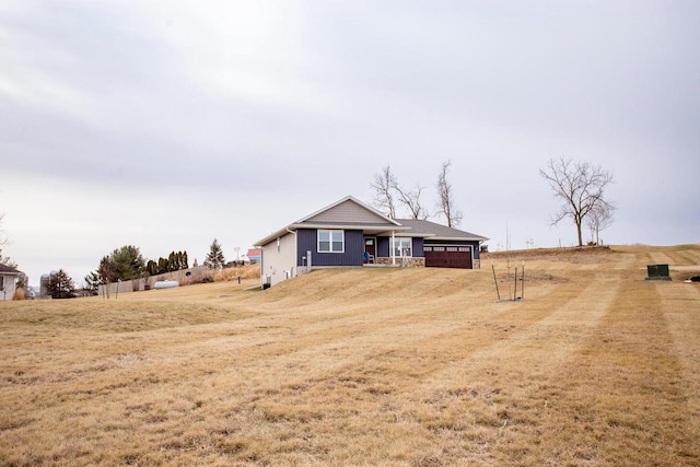 exterior space with a front lawn, a porch, and a garage