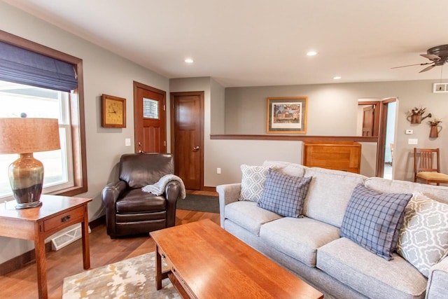 living room with ceiling fan and light wood-type flooring