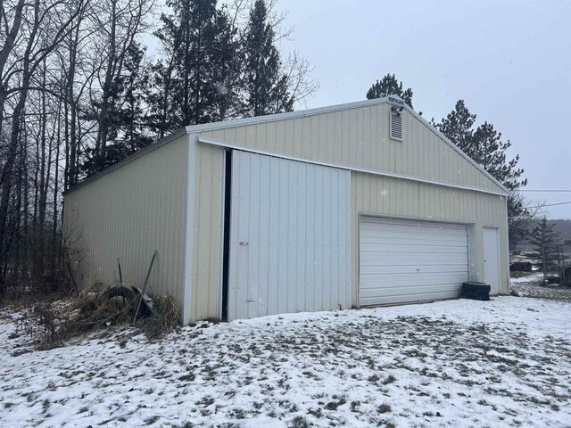 59005 Bill Anderson Rd, Mason, WI 54856 - snow covered garage featuring a garage