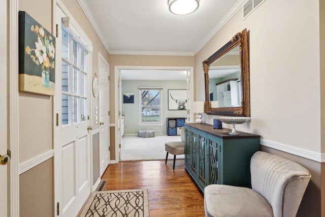 entryway featuring hardwood / wood-style floors and crown molding