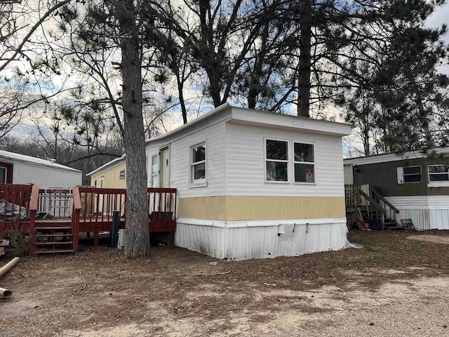 view of side of home with a deck