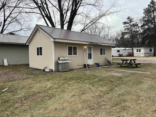 rear view of property with a lawn