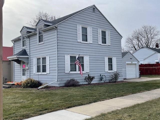 view of front of home featuring a garage and a front lawn