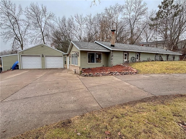 view of front of home with an outbuilding, a front lawn, and a garage