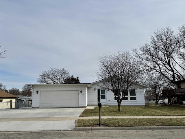 ranch-style house featuring a front lawn and a garage