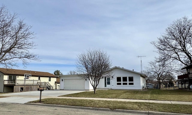 view of front facade featuring a garage, a front lawn, and a deck