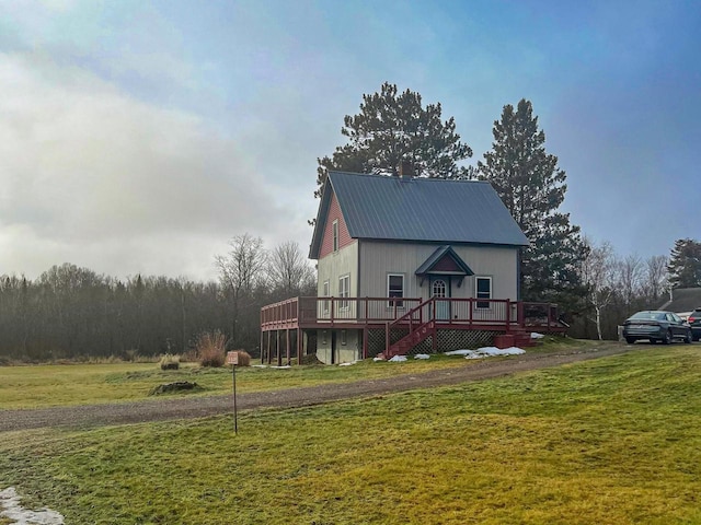 view of front facade with a front yard and a deck