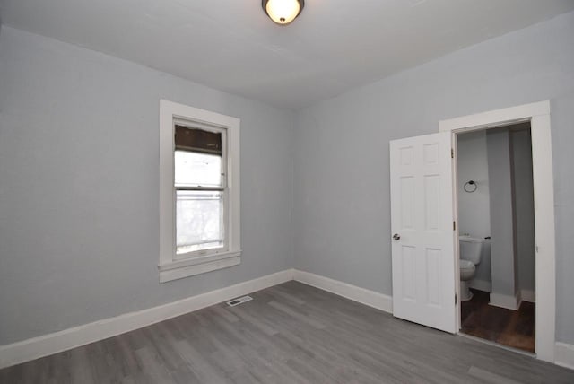 unfurnished room with dark hardwood / wood-style flooring