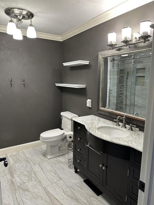 bathroom featuring vanity, toilet, an enclosed shower, and ornamental molding