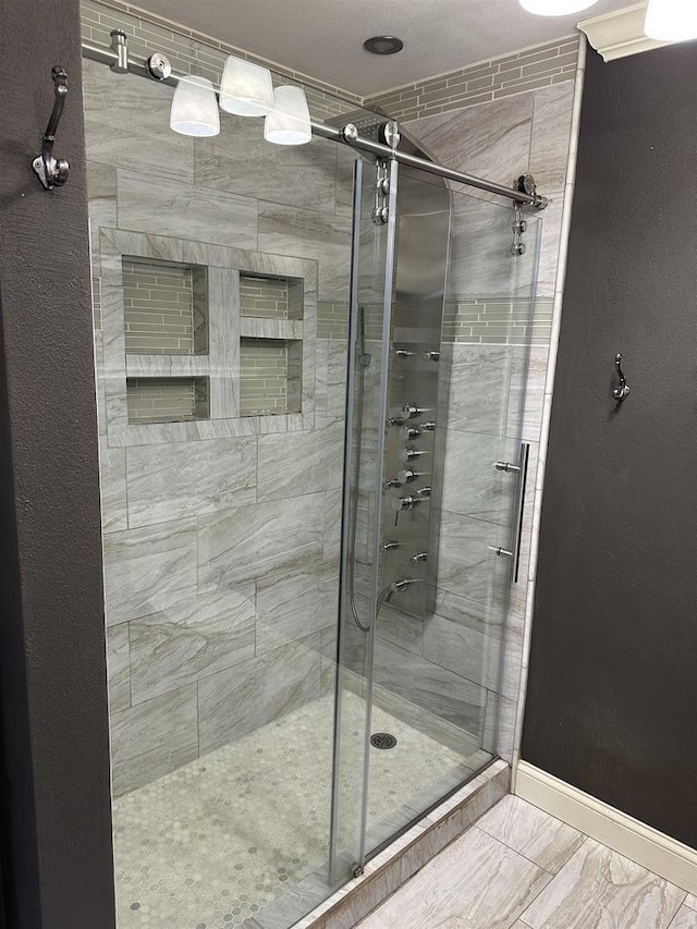 bathroom featuring a shower with door